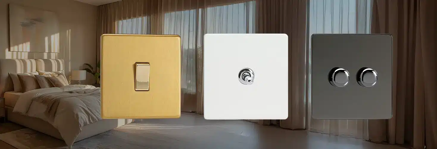Three decorative light switches in brass, white, and dark chrome tones float in a softly lit bedroom setting with a bed and sheer curtains in the background. Three decorative light switches in brass, white, and dark chrome tones float in a softly lit bedroom setting with a bed and sheer curtains in the background.